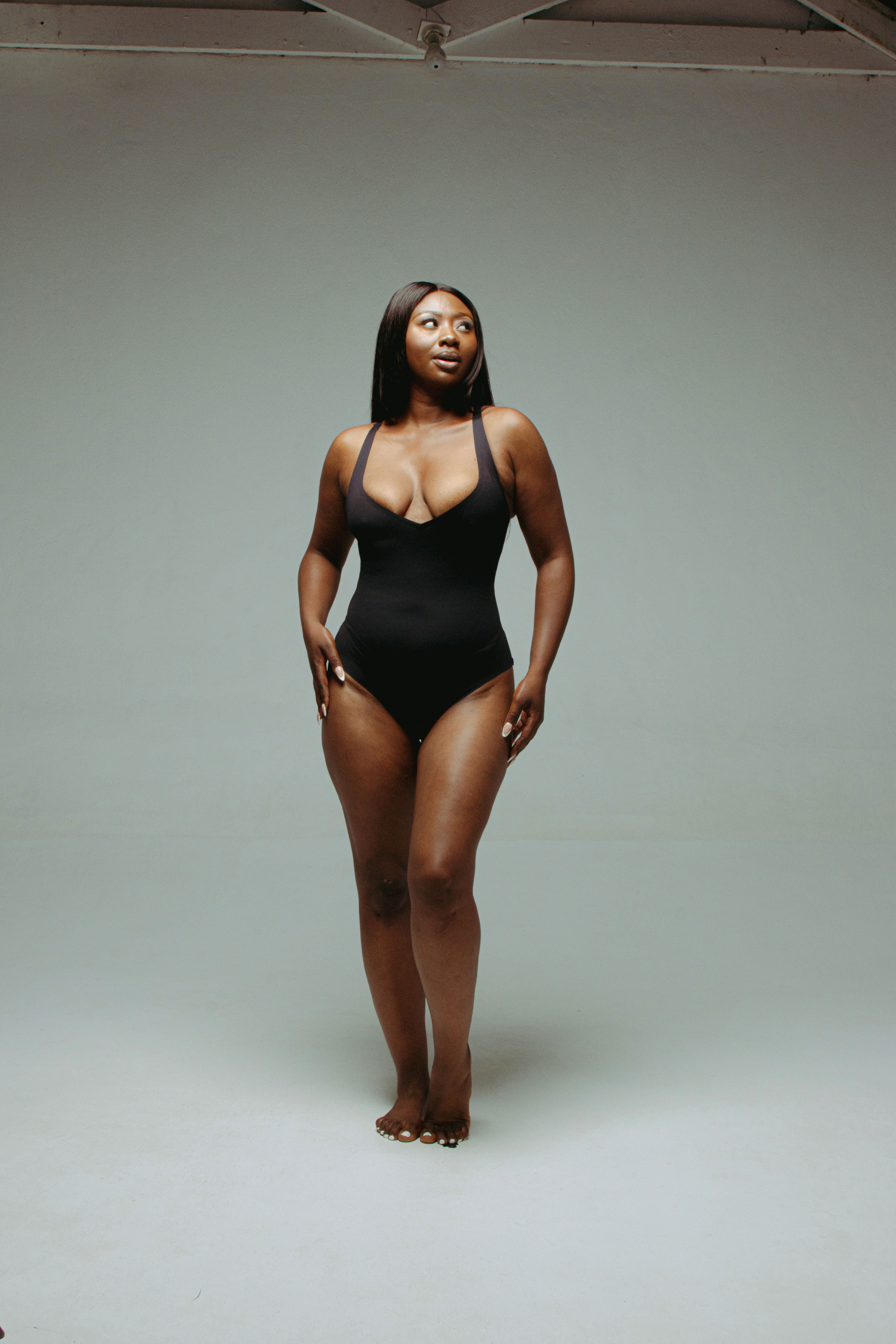 Model wearing Kurv seamless plunge bodysuit with thong back